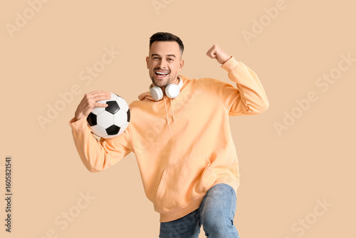 Happy young man with soccer...