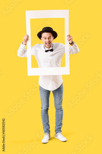 Happy young man with frame ...
