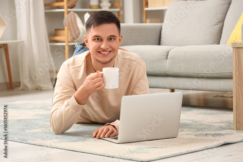 Handsome young man with mug...