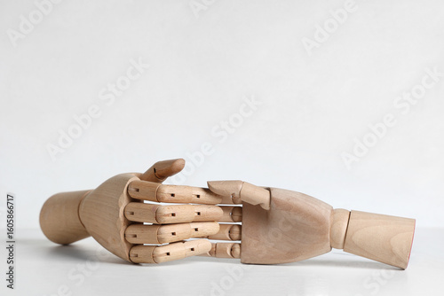 Wooden hands on white table