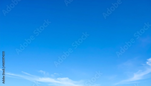 Clear blue sky with wispy clouds