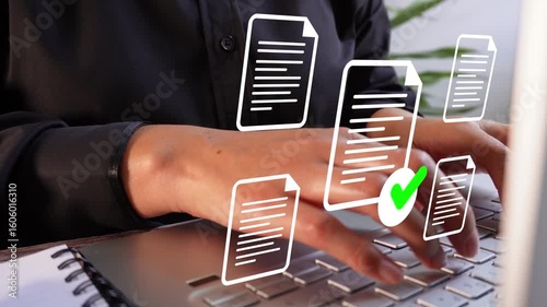 Close-up of a businessman's hands working on a laptop with several document icons floating around