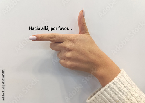 Woman's hand with manicure pointing with gun gesture and the text 