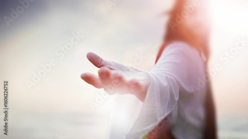 Jesus Christ extending his hand of salvation, the resurrected Jesus leading us into heaven with arms outstretched, Easter background, looping video
