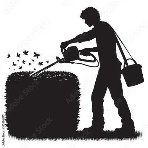 Silhouette of Gardener Trimming a Hedge with Electric Trimmer