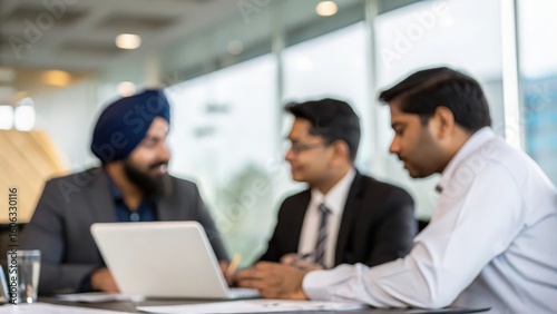 Blurred Conference Room Scene Showing Indian Executives in Deep Discussion
