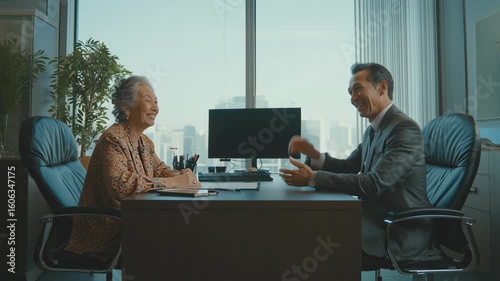 Senior Thai client discussing a retirement savings plan with a financial advisor in a professional Bangkok office.