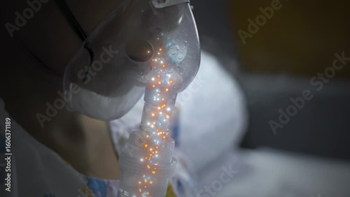 Close-up of patient using nebulizer oxygen mask with visualized airflow particles