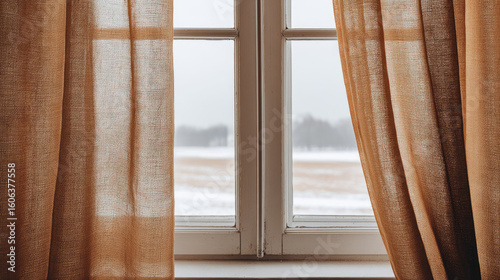 Brown curtain fabric hanging on window with snowy field outside