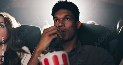 Foto Man, popcorn and suspense movie at theater with snack, audience and entertainment at film screening