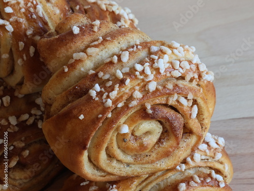 Traditional home-made  finnish cinnamon rolls on wooden background.