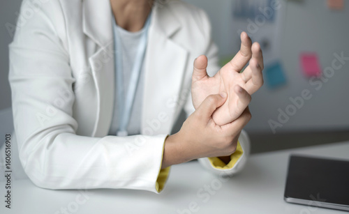 Woman hand with wrist pain numbness and pain in the palm of the hand has pain and tingling in the nerve endings This is a side effect of sitting and working for a long time on a laptop at the office