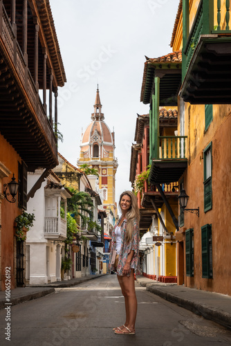 Tourist smiling in cartagena de indias walled city with cathedral of santa catalina de alejandria in background