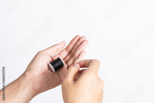 Hands Holding Needle and Thread for Sewing and Housework Tasks
