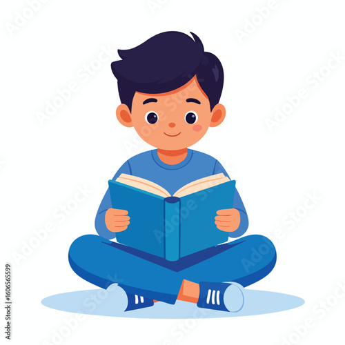 A young boy sits cross-legged, holding and reading an open blue book with a happy expression.