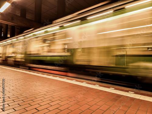 Blurred subway in motion, showing a fast-moving train on a platform. Moving subway in the city of Hanover (30159), Germany, at the Markthalle Landtag stop.
