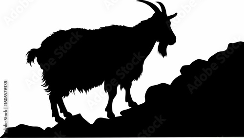 Silhouette of a goat standing on rocks