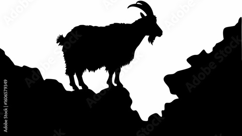Silhouette of a goat standing on a rocky outcrop