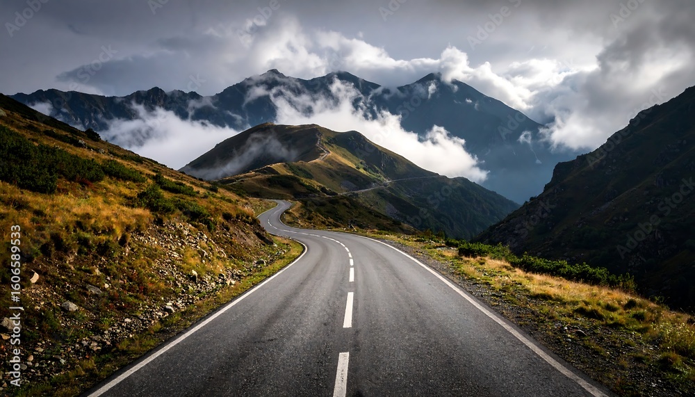 Naklejka premium Winding mountain road through a valley