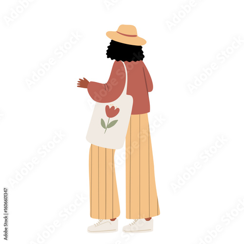 Illustration of a young black woman in wide hat, long yellow pants and crossbody bag standing sideways. Flat vector illustration.