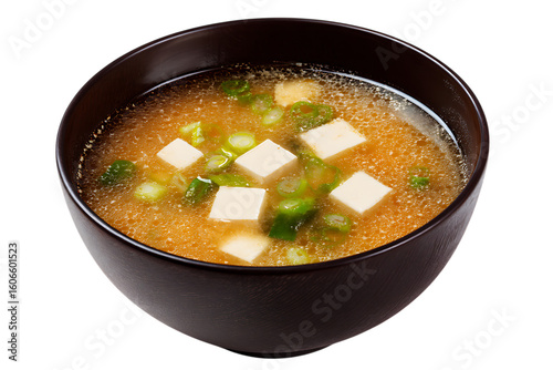 On transparent background a closeup shot of a steaming bowl of japanese miso soup filled with cubes of tofu and