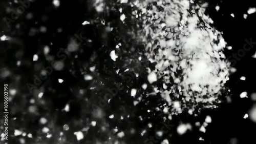 Swirling white snow particles in a realistic slow motion blizzard on a black background