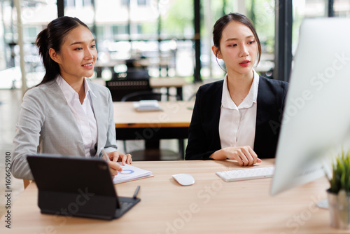 Business people group meeting in the office . Profession asian business women office workers working in team conference with project planning document on meeting table .
