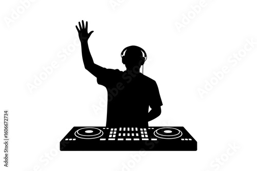 Silhouette of a dj with headphones raising one hand while standing behind a sound mixing console