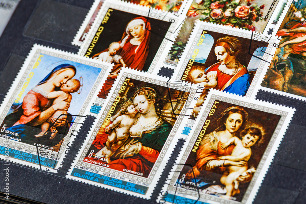 Obraz premium Postage stamps. Collection of stamps and magnifying glass. Collection of world stamps in a stack demonstrates the theme of art. Postage stamps of different countries and times