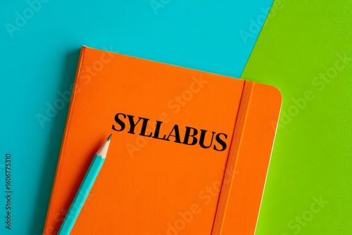 SYLLABUS - word on an orange notepad on a background of multi-colored folders.