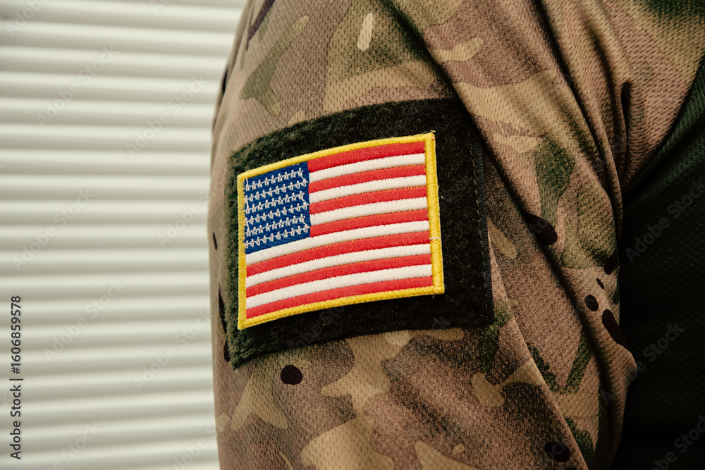 Obraz premium Fragment of military clothing with US flag patch. Army equipment in close-up.