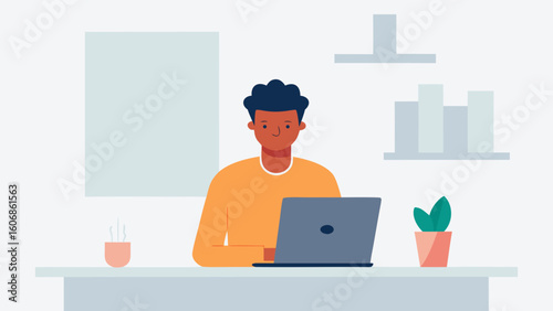 Man working on laptop at desk in minimalist home office