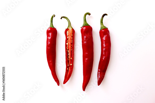Fototapeta Naklejka Na Ścianę i Meble -  Place whole and halved chili peppers together on a white background.