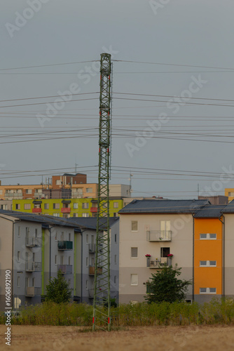 Slika na platnu A telephone pole positioned prominently in front of a continuous row of adjacent