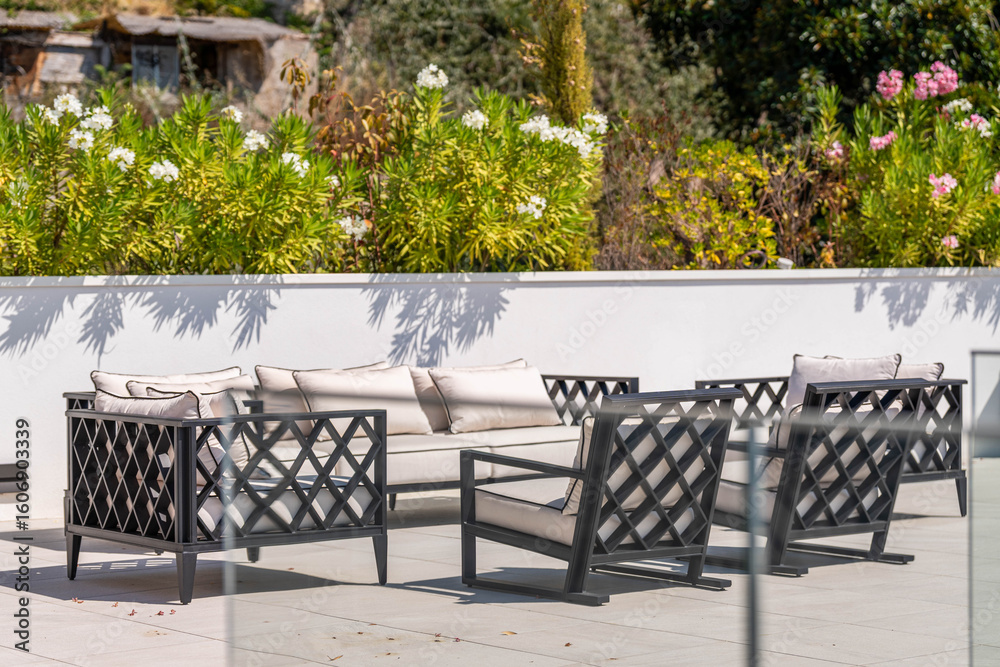 Fototapeta premium Luxury Outdoor Lounge with Modern Sofa Set and Garden View