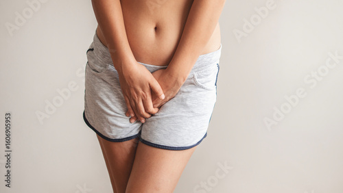 A woman holding her groin