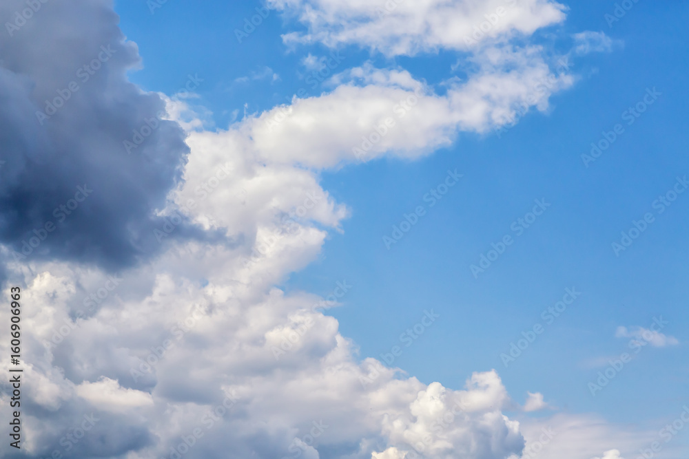 Clouds in the sky shaped like a crescent, white and gray, covering half of the blue sky close-up, white cumulus clouds in a semicircle in the blue sky, Clouds in the sky shaped like a crescent, white and gray, covering half of the blue sky close-up, white cumulus clouds in a semicircle in the blue sky,