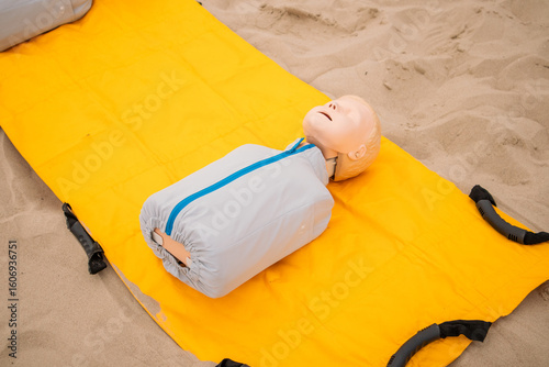 Medical dolls lay on the yellow mat for rescue training