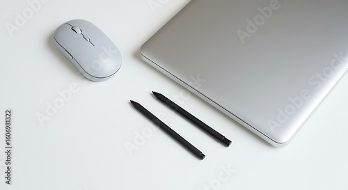 Sleek modern laptop, wireless mouse, and stylus pens ready for creative work and productivity