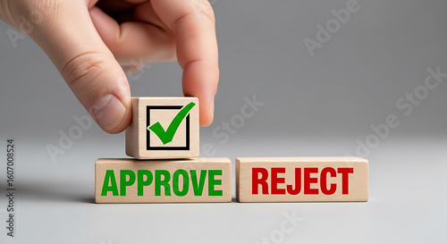 Hand placing approval block on approve reject cubes