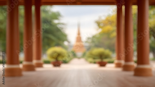 blurred image of temple veranda columns framing gardens and distant chedi, architectural blur