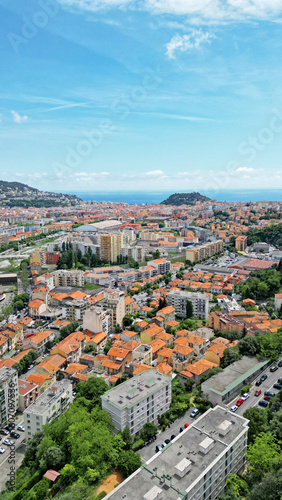 Wallpaper Mural Aerial view of a vibrant coastal city with colorful rooftops, lush greenery, and distant hills, showcasing urban architecture and natural beauty in harmony Torontodigital.ca