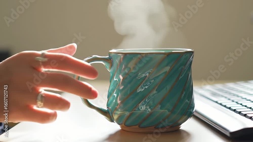 Hot Beverage Steaming in a Teal Mug on a Desk