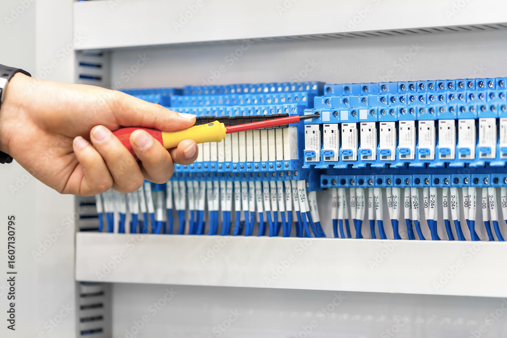 Φωτογραφία Electrician at work inspecting, repair and maintenance cable connection of high voltage power electric line in industrial distribution fuseboard