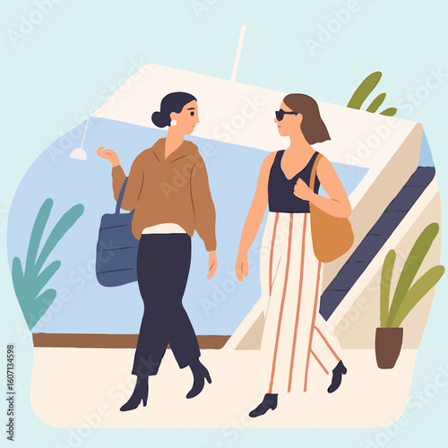 Two women walking and chatting casually in modern indoor setting  