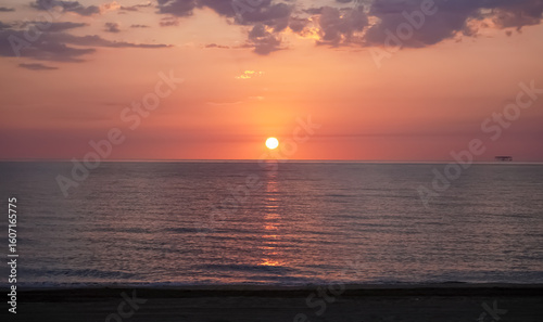 Fiery dawn over the sea. Morning serenity