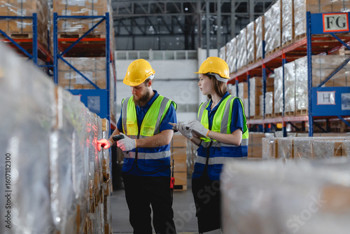 Male and female warehouse workers scanning barcode and verifying auto parts with clipboard, showing teamwork and accuracy in smart automotive logistics process, Auto parts logistics and transport