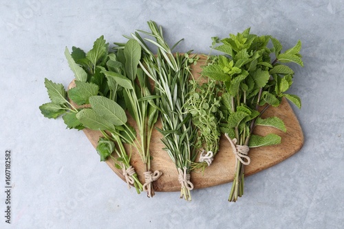 Fototapeta Naklejka Na Ścianę i Meble -  Different fresh green herbs on grey table, top view