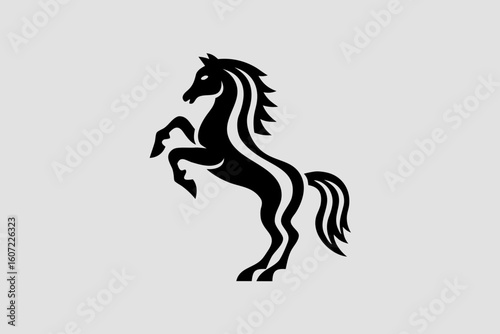 A black silhouette of a horse rearing up, its mane flowing in the wind, isolated on white background