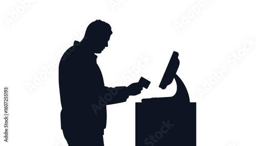 Silhouette of a man making a payment at a checkout terminal  
